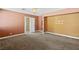 Main bedroom featuring neutral tones, plush carpeting, and a peek into the bathroom at 1655 E Hacienda Ave, Las Vegas, NV 89119