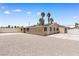 Back of the house featuring a large backyard, a gravel lot, and solar panels at 1655 E Hacienda Ave, Las Vegas, NV 89119