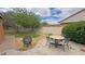 Large backyard featuring a dining area, fire pit, and expansive lawn under a sunny sky at 2598 Fountain Ave, Pahrump, NV 89048