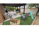 Cozy backyard with covered patio, outdoor seating, play area, and landscaped yard at 2598 Fountain Ave, Pahrump, NV 89048