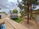 Spacious backyard features a trampoline, a brick sidewalk and a pine tree at 2598 Fountain Ave, Pahrump, NV 89048