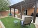 Inviting backyard with covered patio, outdoor seating, green lawn, and play area at 2598 Fountain Ave, Pahrump, NV 89048