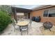 Backyard with covered patio, dining table, barbecue grill, and a cozy fire pit area at 2598 Fountain Ave, Pahrump, NV 89048