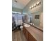 Neutral bathroom features a vanity, a toilet, a large mirror, and a shower with a patterned curtain at 2598 Fountain Ave, Pahrump, NV 89048