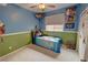Colorful bedroom featuring playful decor, carpet floors, and ample natural light at 2598 Fountain Ave, Pahrump, NV 89048