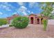 Charming single-story home featuring a well-manicured front yard with desert landscaping and mature shrubbery at 2598 Fountain Ave, Pahrump, NV 89048