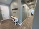 Well-lit hallway with shoe storage bench, fresh paint, and a view leading to other rooms in the home at 2598 Fountain Ave, Pahrump, NV 89048