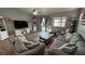 Inviting living room featuring vaulted ceilings, a ceiling fan, ample seating, and access to the outdoor area at 2598 Fountain Ave, Pahrump, NV 89048