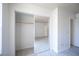 Bedroom closet with mirror doors and ample storage space, bright floors at 2606 S Durango Dr # 122, Las Vegas, NV 89117