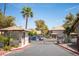 Gated community entrance with tiled roof guardhouse and lush landscaping at 2606 S Durango Dr # 122, Las Vegas, NV 89117