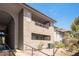 Exterior view of condo building with desert landscaping and stucco facade at 2606 S Durango Dr # 122, Las Vegas, NV 89117