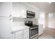 Bright kitchen features white cabinets, stainless steel appliances, and stylish backsplash at 2606 S Durango Dr # 122, Las Vegas, NV 89117