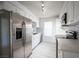 Modern kitchen with stainless steel appliances, white cabinets, and mosaic backsplash at 2606 S Durango Dr # 122, Las Vegas, NV 89117