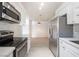 Modern kitchen with stainless steel appliances and white cabinets, open to living area at 2606 S Durango Dr # 122, Las Vegas, NV 89117