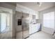 Kitchen features stainless steel appliances, white cabinets, and stone countertops at 2606 S Durango Dr # 122, Las Vegas, NV 89117