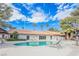 Sparkling community pool surrounded by lounge chairs, lush landscaping, and clear skies at 2606 S Durango Dr # 122, Las Vegas, NV 89117