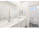 Well-lit bathroom featuring double sinks, a large mirror, and a tub-shower combo at 267 Cordelia Cove Ave # 812, Henderson, NV 89011