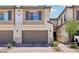 Inviting townhome featuring a two-car garage and desert landscaping at 267 Cordelia Cove Ave # 812, Henderson, NV 89011