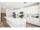 Well-lit kitchen featuring stainless steel appliances, quartz countertops, and modern white cabinetry at 267 Cordelia Cove Ave # 812, Henderson, NV 89011