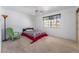 Bedroom with neutral carpet, ceiling fan, window, and accent furniture at 2851 S Valley View Blvd # 2148, Las Vegas, NV 89102