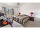 Cozy bedroom with a queen size bed, nightstands, a chair, and neutral carpet at 2851 S Valley View Blvd # 2148, Las Vegas, NV 89102
