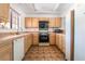 Functional kitchen features tile countertops, wood cabinets, and essential appliances, providing a practical space for cooking at 2851 S Valley View Blvd # 2148, Las Vegas, NV 89102