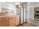 Connected kitchen with tiled counters and wood cabinets with view into the living room at 2851 S Valley View Blvd # 2148, Las Vegas, NV 89102