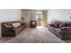 Bright living room featuring neutral carpet, a pair of sofas, and large windows that let in natural light at 2851 S Valley View Blvd # 2148, Las Vegas, NV 89102