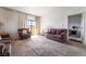 Inviting living room featuring neutral carpet, a pair of sofas, and large windows that let in natural light at 2851 S Valley View Blvd # 2148, Las Vegas, NV 89102