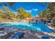 Refreshing community pool area featuring lounge chairs and sun umbrellas, perfect for relaxation and leisure at 2851 S Valley View Blvd # 2148, Las Vegas, NV 89102