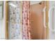 Shower stall with glass doors, pink tile and shower curtain, and safety grab bars at 2851 S Valley View Blvd # 2148, Las Vegas, NV 89102