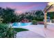 Stunning backyard featuring a custom pool with rock waterfall and lush landscaping, perfect for relaxation at 2940 Cimini Ct, Henderson, NV 89052
