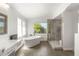 Bright bathroom with a standalone tub and modern glass enclosed shower at 2940 Cimini Ct, Henderson, NV 89052