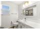 Well-lit bathroom with a modern vanity, large mirror, and a separate tiled shower area at 2940 Cimini Ct, Henderson, NV 89052