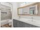 Bright bathroom featuring a dual vanity and large mirror at 2940 Cimini Ct, Henderson, NV 89052