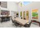 Elegant dining room with high ceilings, a modern table, and a view of the backyard pool at 2940 Cimini Ct, Henderson, NV 89052