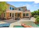Beautiful home exterior highlighting the outdoor living space with pool, spa, and covered patio at 2940 Cimini Ct, Henderson, NV 89052