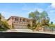 Stunning two-story home featuring a three-car garage, desert landscaping and gated entrance at 2940 Cimini Ct, Henderson, NV 89052