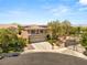 Stunning two-story home featuring a three-car garage, desert landscaping and gated entrance at 2940 Cimini Ct, Henderson, NV 89052