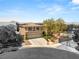 Stunning two-story home featuring a three-car garage, desert landscaping and gated entrance at 2940 Cimini Ct, Henderson, NV 89052