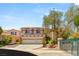 Two-story home featuring a three-car garage, desert landscaping, and gated entrance at 2940 Cimini Ct, Henderson, NV 89052