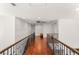 Hallway with hardwood floors and a decorative railing provides a clean transition between spaces at 2940 Cimini Ct, Henderson, NV 89052