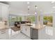 Gourmet kitchen featuring a stainless steel dishwasher, granite countertops and a view of the open living area at 2940 Cimini Ct, Henderson, NV 89052