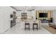 Open-concept kitchen featuring stainless steel appliances, granite countertops, and a breakfast bar perfect for dining at 2940 Cimini Ct, Henderson, NV 89052