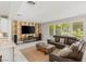 Well-lit living room with a comfortable seating area and entertainment center at 2940 Cimini Ct, Henderson, NV 89052