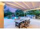 Outdoor dining area with a built-in grill, covered patio, and view of the sparkling pool at 2940 Cimini Ct, Henderson, NV 89052