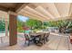 Inviting outdoor dining area with a pergola, overlooking a pool and lush landscaped backyard at 2940 Cimini Ct, Henderson, NV 89052
