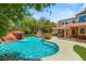 Beautiful backyard pool with rock waterfall feature and covered patio perfect for outdoor entertaining at 2940 Cimini Ct, Henderson, NV 89052