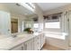 Bathroom with double sinks, soaking tub, shower, and access to walk-in closet at 2970 Strathspey Ct, Henderson, NV 89044