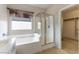 Bathroom featuring a bathtub, glass-enclosed shower, and access to a walk-in closet at 2970 Strathspey Ct, Henderson, NV 89044